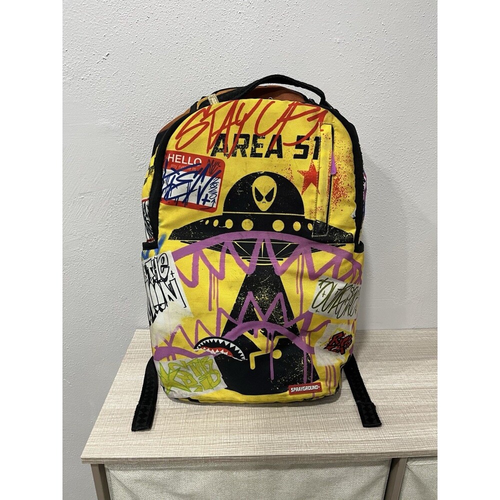Sprayground Area 51 Alien Trashed Sign Backpack Yellow Graffiti Shark Mouth
